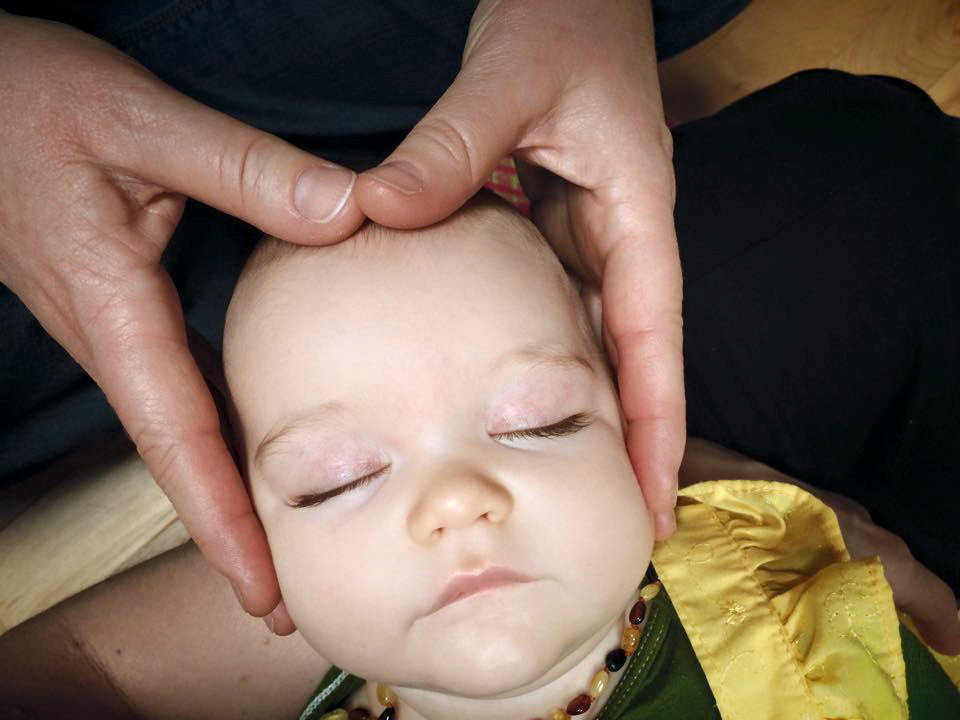 Valerie treating a baby